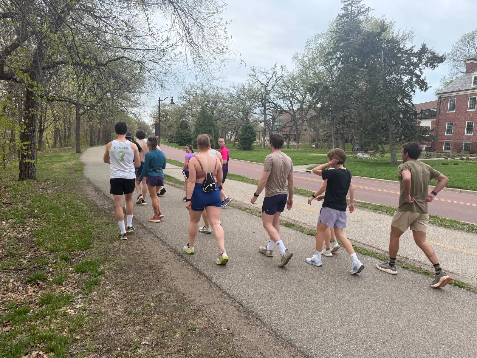 Members lined up on the track on a gray April evening for the first Track Club of the season
